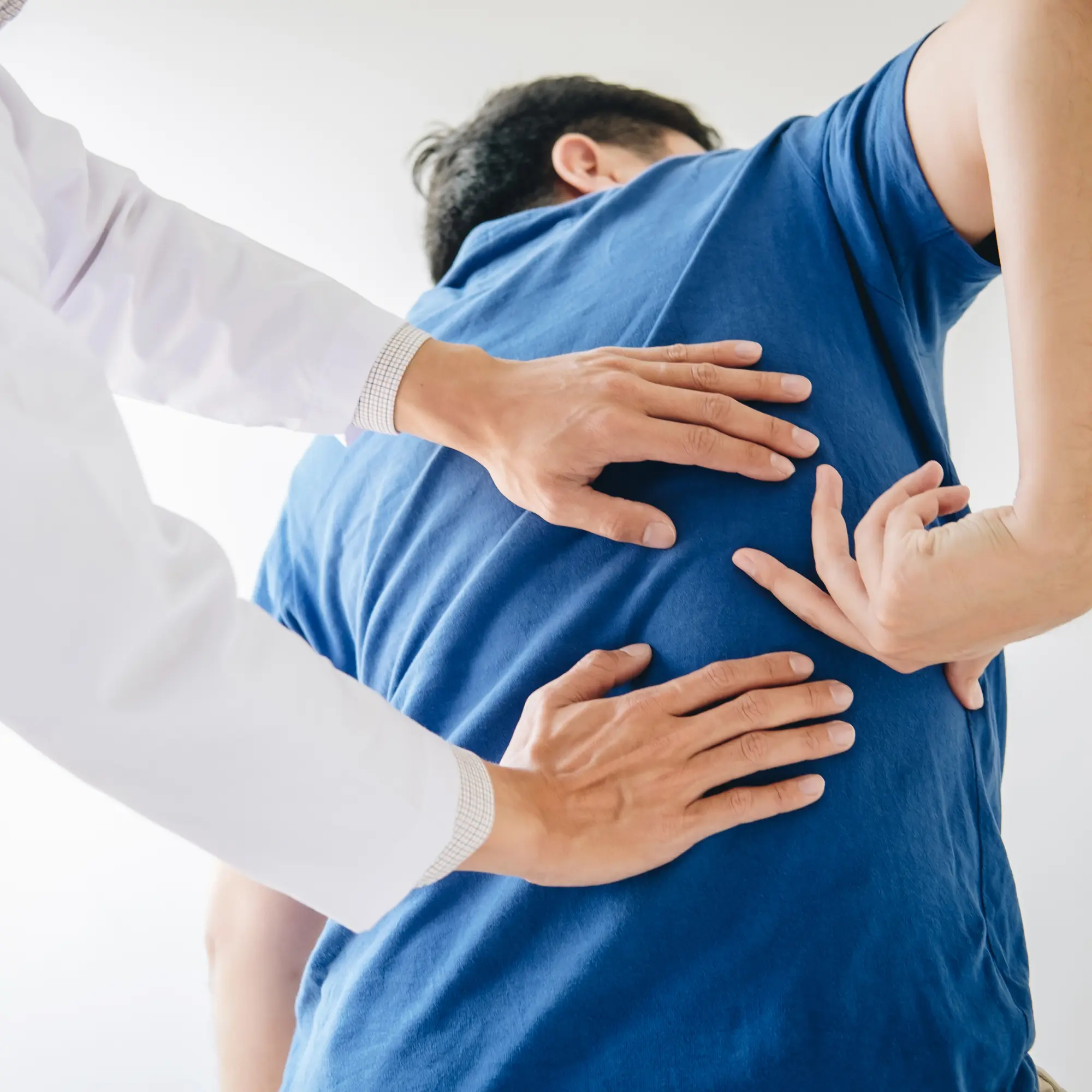 Orthopaedic specialist examining a patient's back and spine in Niagara Falls, NY